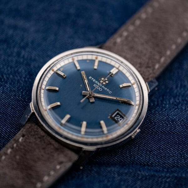 Angled view of the vintage Eterna-Matic 1000, sunburst dial catching light across the applied hour markers.