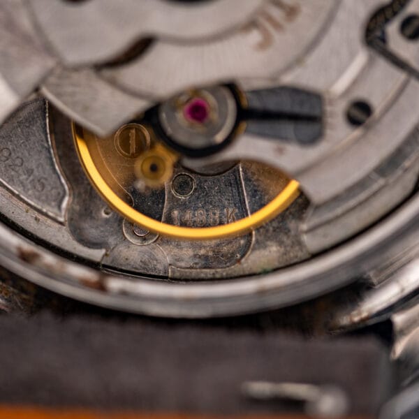 Macro of the Eterna caliber 1488K bridge clearly stamped 1488K beside a jeweled ruby setting.