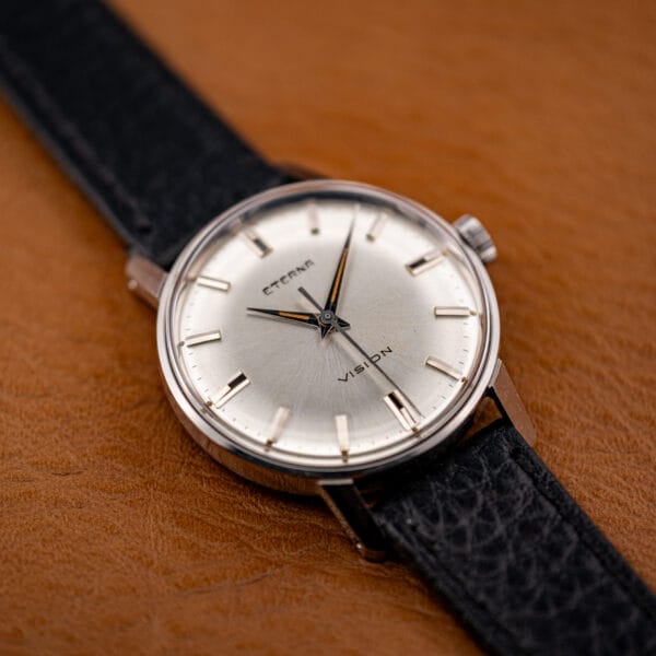 Eterna Vision dial angled toward the light, showing warm toning near the six and applied faceted markers.