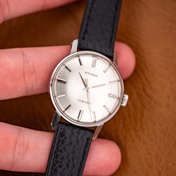 Macro of the signed fluted stainless crown and polished case band on this hand-wound Eterna.