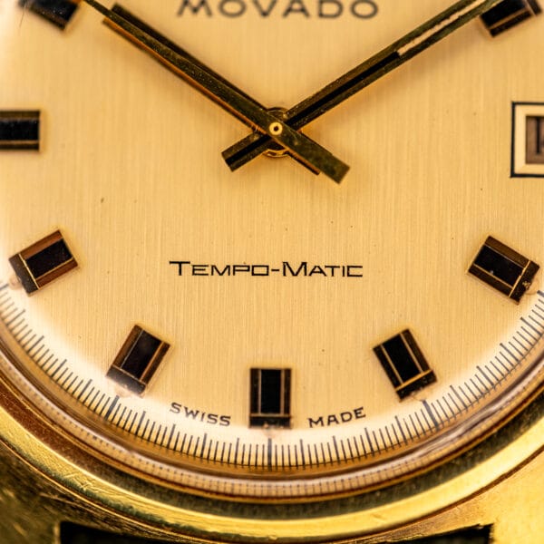 Movado Tempo-Matic dial printing hyphenated below center, above the split SWISS MADE line
