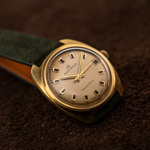 Movado 138-625-502 cushion case and notched lugs on forest green Italian suede strap