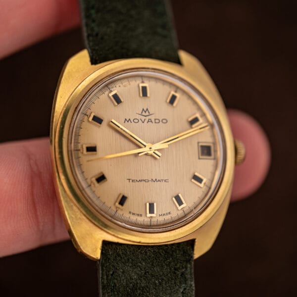 Movado Tempomatic Sub-Sea held in hand, full champagne dial with Tempo-Matic printing and date