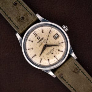 Omega Constellation 2943-2 top down on olive ostrich strap, off-white speckled dial with date at three