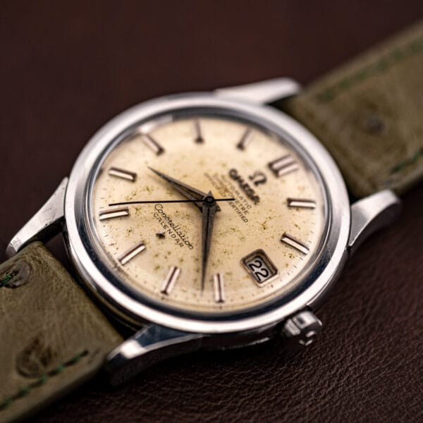 Angled view of the 35mm steel Constellation Calendar case, dial speckling catching light across the field