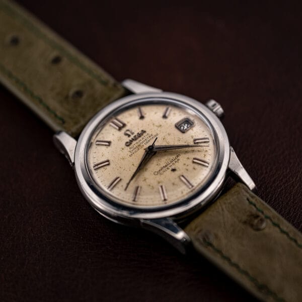 Omega Constellation 2943-2 tilted to show the polished bezel, domed crystal edge and dark dauphine hands
