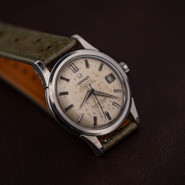 Omega Constellation 2943-2 on its side, lug facets and polished case band catching studio light