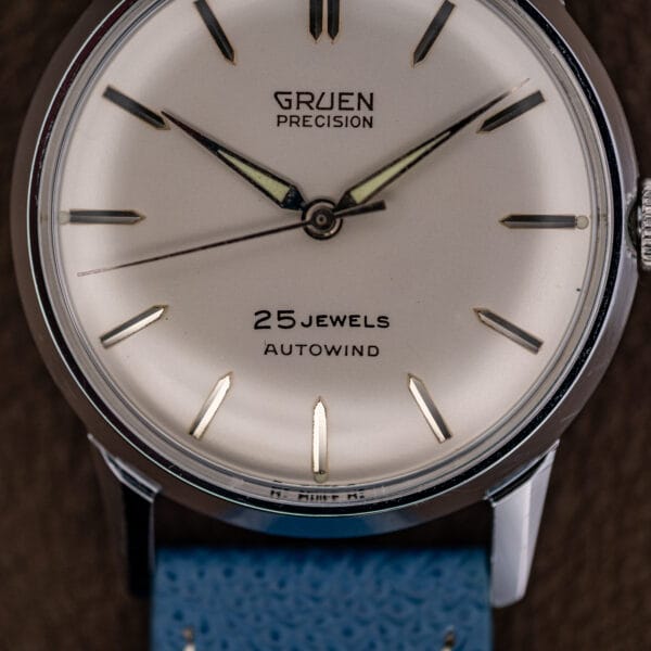 Close-up of the lower dial reading 25 Jewels Autowind above six, with the thin sweep seconds hand.