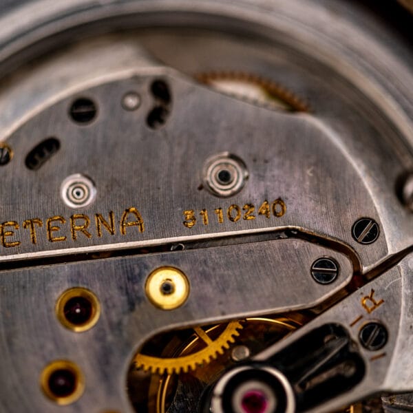 Macro of Eterna 965 bridge, gilt ETERNA signature, serial 3110240, gold chatons and regulator marked R