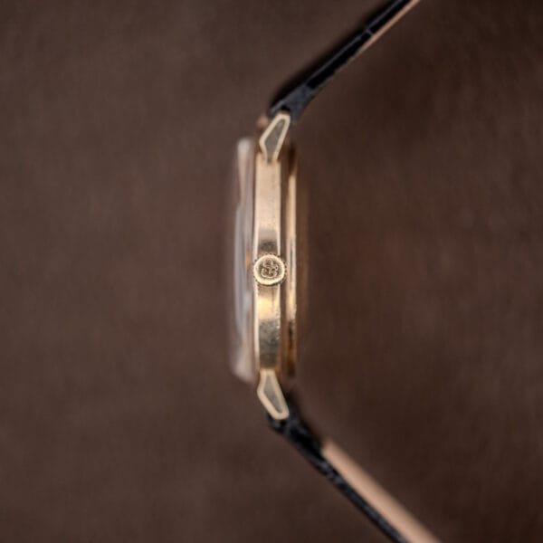 Girard Perregaux Gyromatic gold filled crown signed with an interlocking cipher, slim case band alongside