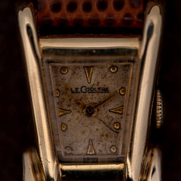 Aged tan LeCoultre dial with applied gold arrowhead markers and dauphine hands, honest patina across the whole surface.