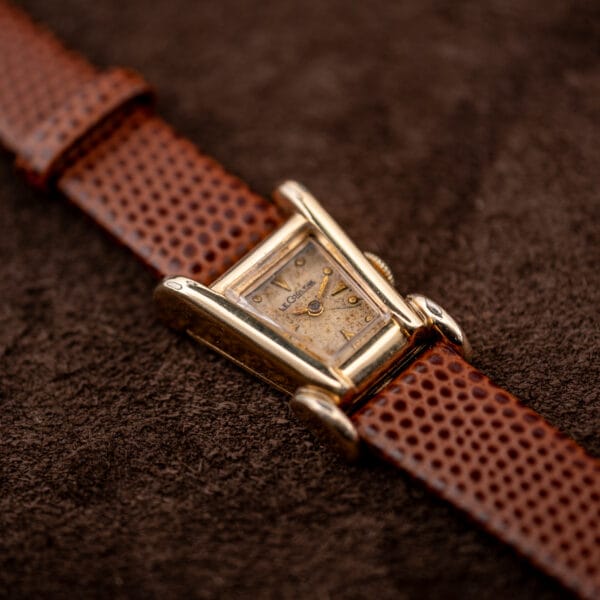 Macro of the LeCoultre Aristocrat dial and flared gold filled lugs, arrowhead markers and gold dauphine hands.