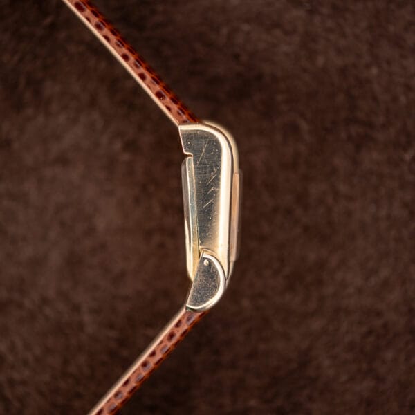 Profile of the gold filled LeCoultre case showing the stepped bezel and flared lug geometry from the side.