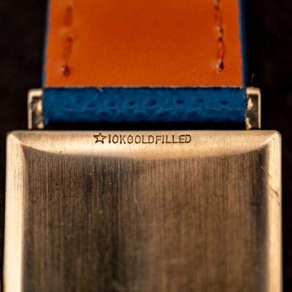 Macro of the Longines Tank caseback stamping, five-pointed star preceding 10K GOLD FILLED above the lug