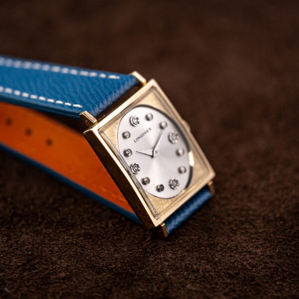 Longines 3217-428 three quarter view over blue leather strap showing its contrasting orange calfskin lining