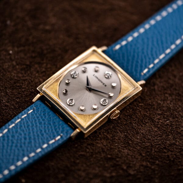 Longines Tank 3217-428 from above, twelve applied markers ringing the recessed silver dial in textured gold