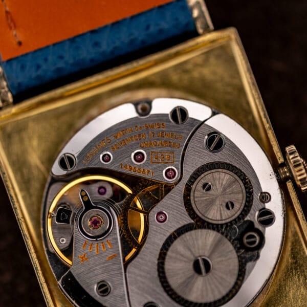 Macro of Longines 428 movement engraved LONGINES WATCH Co SWISS with serial 14965671 beside the caliber number