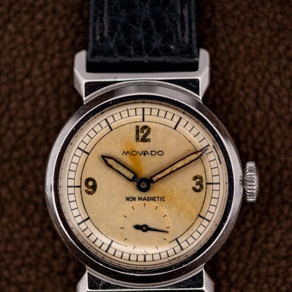 Movado Acvatic dial close up showing Non Magnetic printing, blued hands and subsidiary seconds at six.