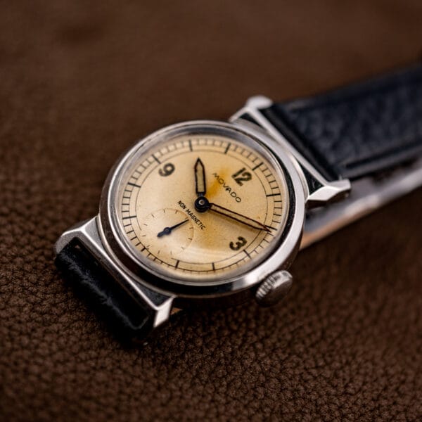 Vintage Movado Acvatic three quarter dial view with warm honey toned patina and blued hands.