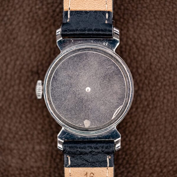 Polished stainless steel Movado caseback exterior with sixteen millimeter lug spacing.