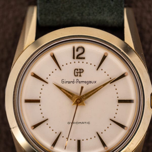 Girard-Perregaux Gyromatic dial macro showing the GP monogram, full signature and applied 12 at noon