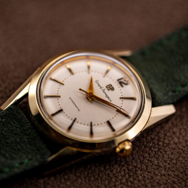 Girard-Perregaux Gyromatic white dial and faceted lugs viewed at an angle with the signed gold crown