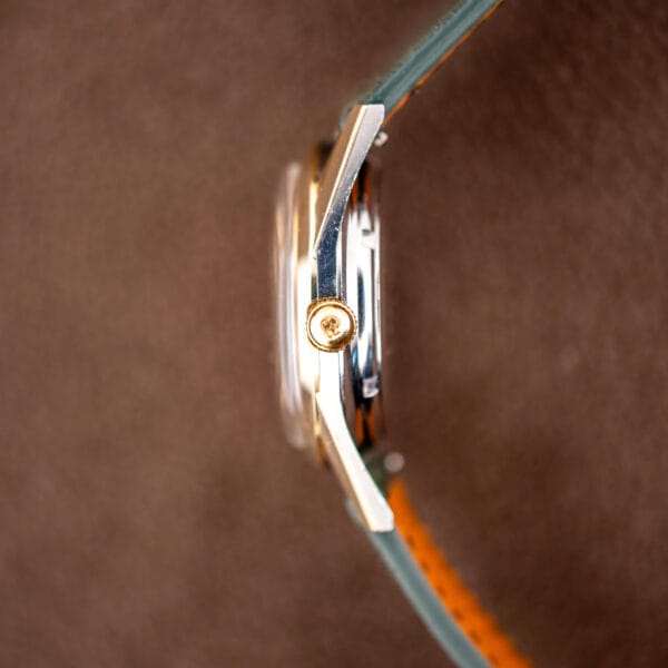 Girard-Perregaux Gyromatic profile with GP signed gold crown where the gold cap meets the steel case band