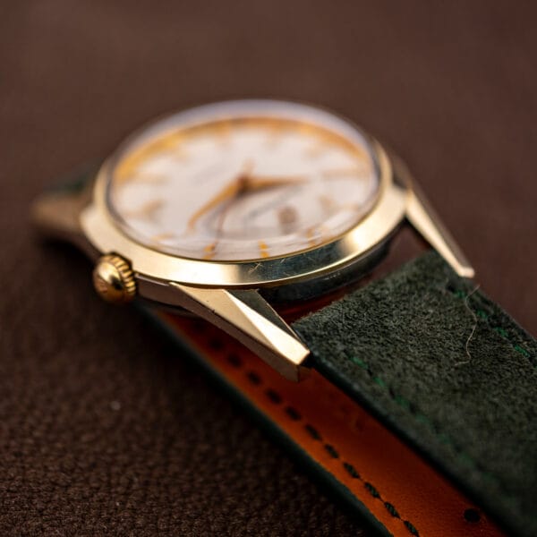 Girard-Perregaux Gyromatic side profile with fluted signed crown and forest green suede strap stitching
