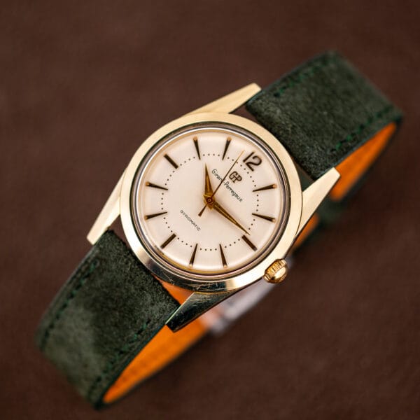 Girard-Perregaux Gyromatic on forest green Italian suede strap showing the tan leather lining
