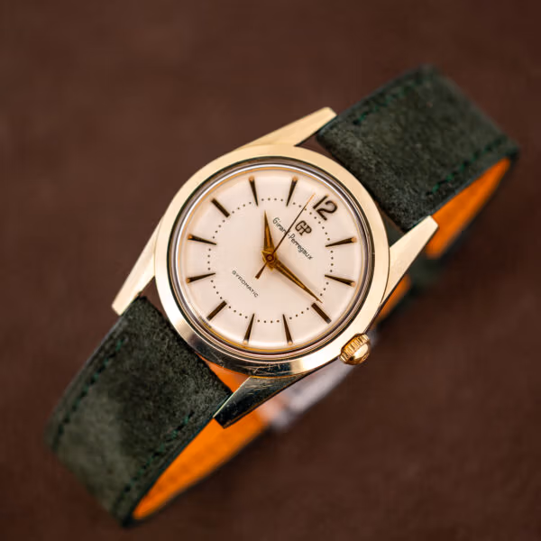 Girard-Perregaux Gyromatic on forest green Italian suede strap showing the tan leather lining