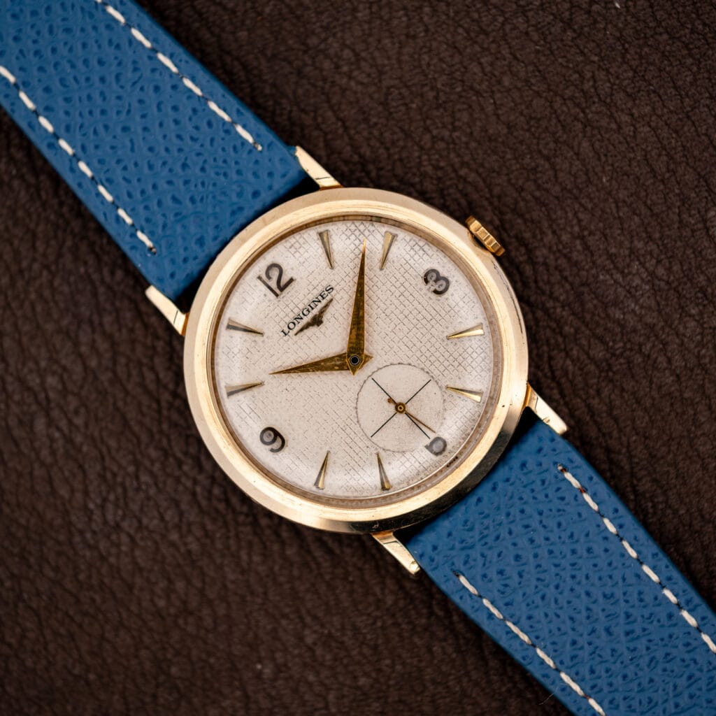 Longines waffle dial Ref. 1044 in 10k gold filled case on blue leather strap, gold dauphine hands