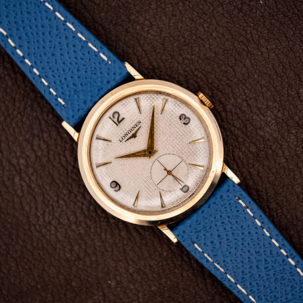 Longines waffle dial Ref. 1044 in 10k gold filled case on blue leather strap, gold dauphine hands