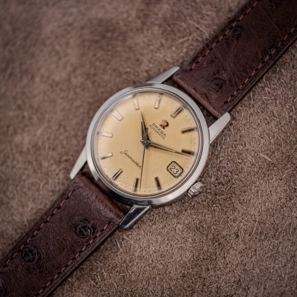 Angled view of the Omega Seamaster 14760 stainless case, signed crown and chocolate brown ostrich leather strap