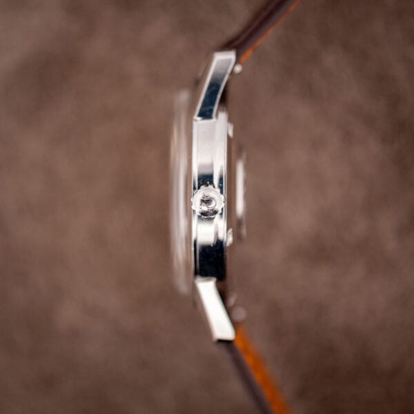Close-up of the Omega Seamaster 14760 crown stamped with the Omega symbol beside the case flank