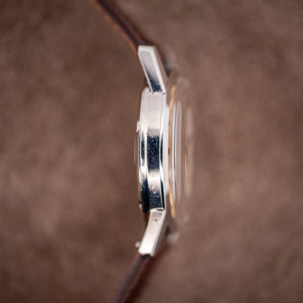 Side profile of the Omega Seamaster 14760 stainless steel case showing slim bezel and domed crystal
