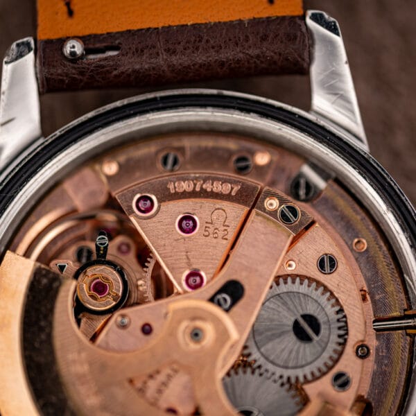 Macro of the Omega caliber 562 bridge stamped with the Omega symbol, 562 and serial number 19074597