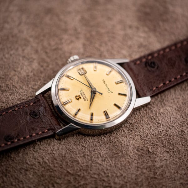 Omega Seamaster 14760 dial angled in soft light, dauphine hands and applied batons above Seamaster script