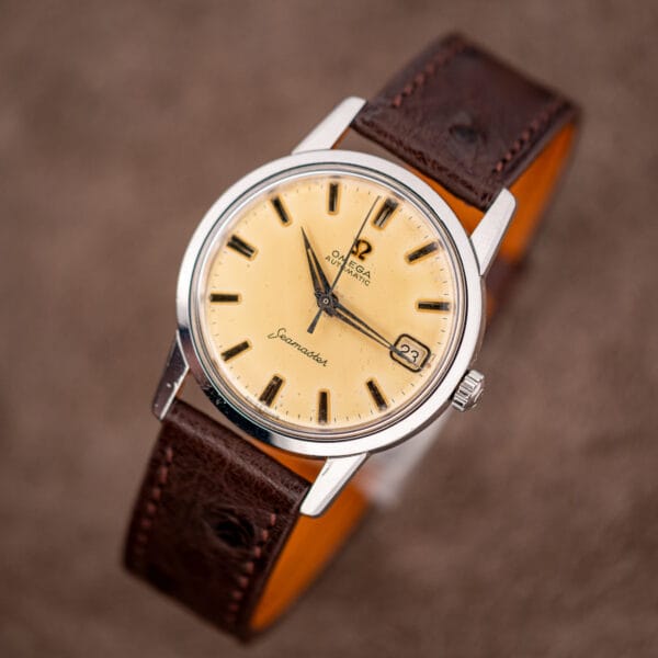 Vintage Omega Seamaster 14760 on brown ostrich strap, date window at three and polished stainless bezel