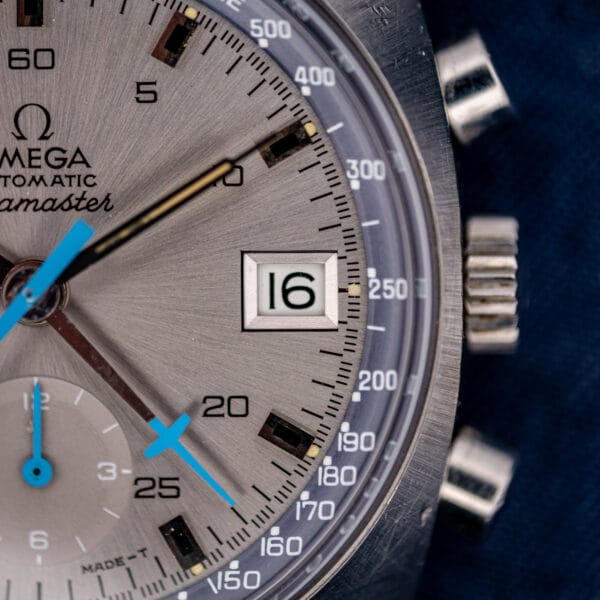 Omega 176.007 framed date window at three o clock beside the tachymetre flange and fluted signed crown