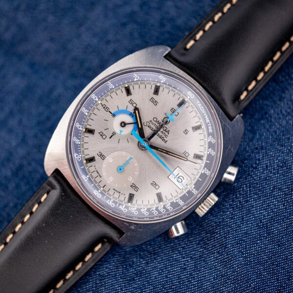 Omega Seamaster 176.007 chronograph flat on denim with black leather strap and contrast cream stitching