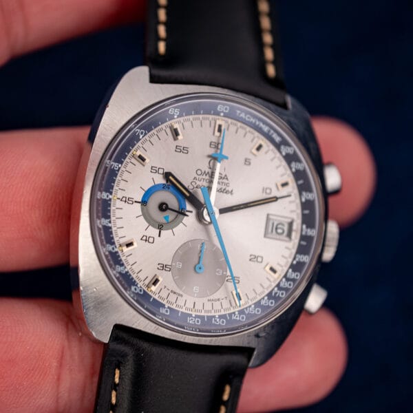 Vintage Omega Seamaster 176.007 held in hand showing dial proportions against fingers for scale