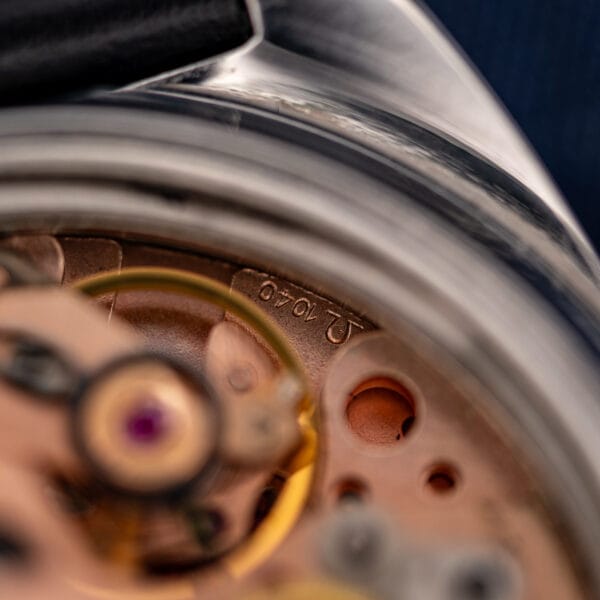Omega calibre 1040 movement bridge macro stamped with the Omega symbol and caliber number 1040
