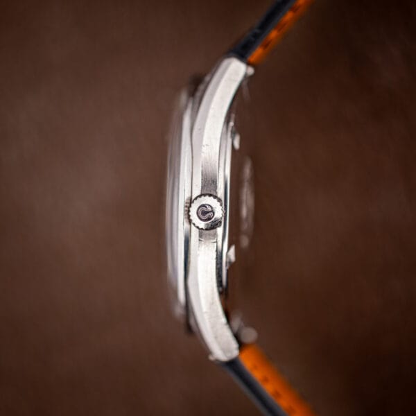 Omega 166.032 case profile with Omega-signed crown, showing the slim brushed case band and curved lugs