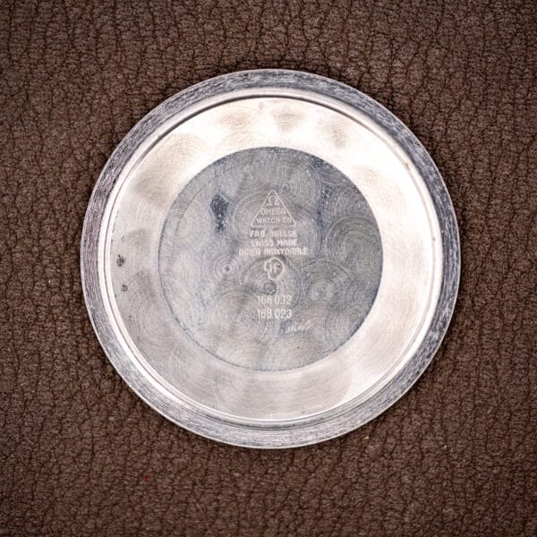 Omega 166.032 inner caseback stamped FAB SUISSE, SWISS MADE, ACIER INOXYDABLE with references 166 032 and 168 023