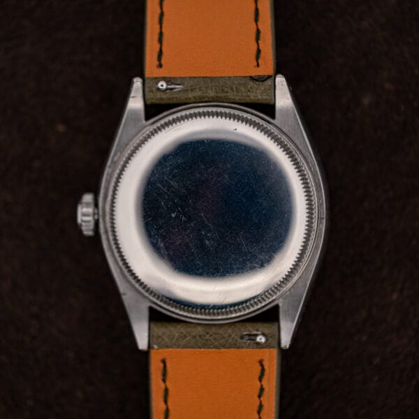 Domed stainless steel caseback of the Rolex 6085 with fine coin edge knurling and honest wear