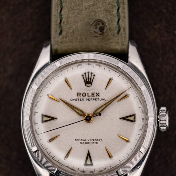 Rolex 6085 dial macro with applied coronet, gold triangles at three six nine and blued sweep seconds hand