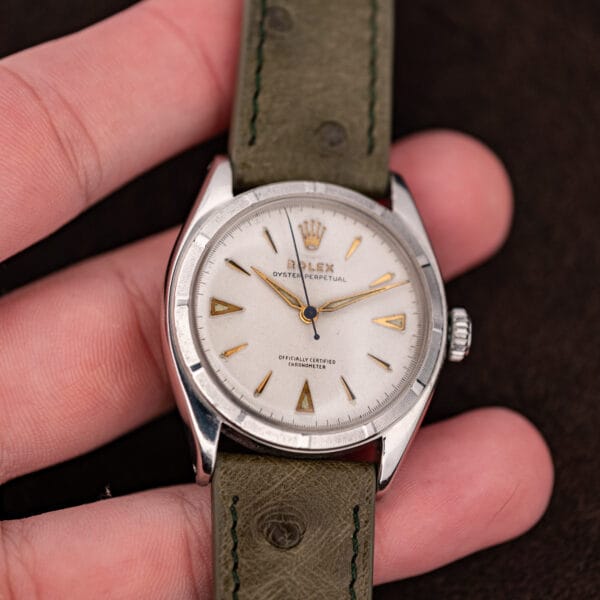 Rolex 6085 in hand, white dial with aged luminous triangles at three six nine and blued seconds hand