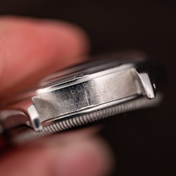 Reference 6085 and MODELE DEPOSE stamped between the upper lugs of the Rolex Oyster Perpetual case