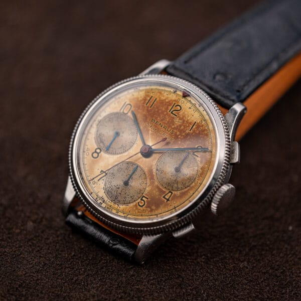 Benrus Sky Chief aged dial at an angle with the red triangle marker at twelve o'clock