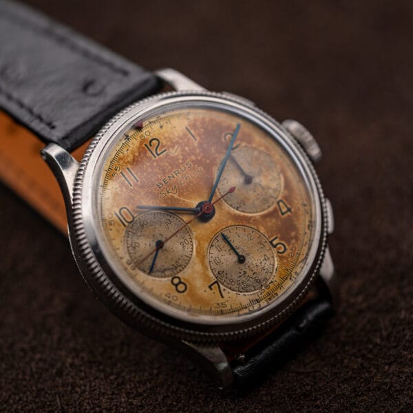 Benrus Sky Chief blued steel hands and red chronograph seconds hand over an aged amber dial